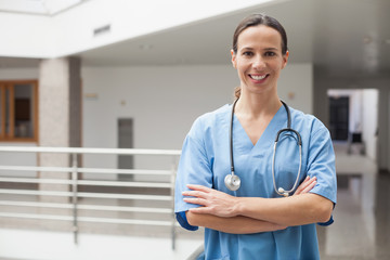 Smiling nurse with crossed arms