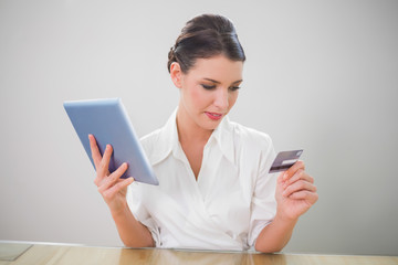 Fototapeta premium Calm pretty businesswoman shopping online