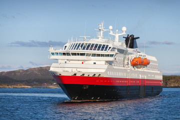 Fototapeta premium Big Norwegian passenger cruise ship sails in fjord