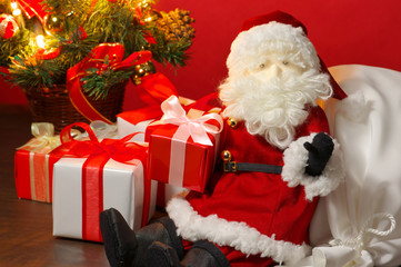 Stuffed toy Santa Claus and many Christmas presents.