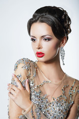 Elegance. Luxurious Woman in Dress with Sequins and Jewels
