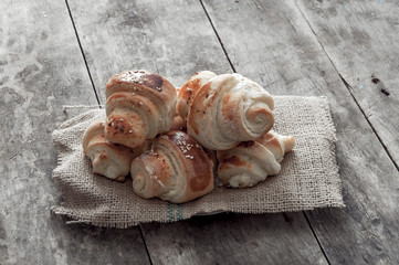 Croissant over wooden background