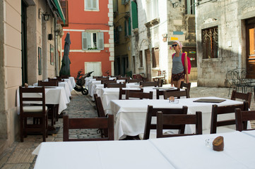 tourist posing in front of empty restaurant