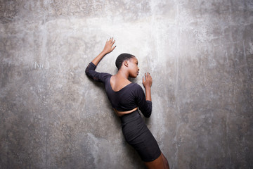 Fototapeta na wymiar Woman leaning on a concrete wall