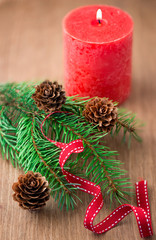 Christmas decoration: fir sprig,candles, cones