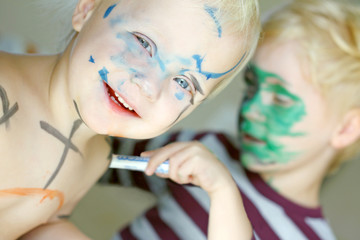 Children Coloring Their Faces with Markers