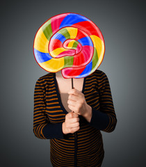 Fototapeta premium Young woman holding a lollipop