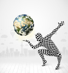 man in full body suit holding planet earth
