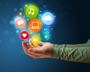Multimedia icons in the hand of a woman