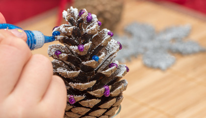 Girl making home made Christmas decoration.