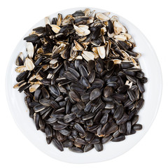 top view of sunflower seeds and husks on plate