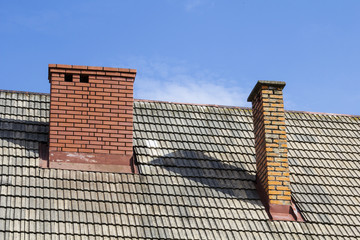 Fototapeta premium two brick chimneys on the roof