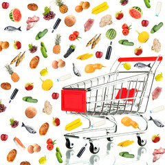 Fototapeta na wymiar Food products flying out around shopping cart isolated on white