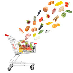 Food products flying out of shopping cart isolated on white