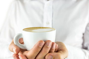 Holding cup of cappuccino