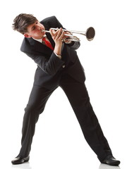 Portrait of a young man playing his Trumpet plays isolated white