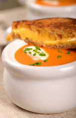 Delicious bowl of tomato soup with grilled cheese sandwich