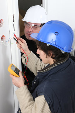 Worker using a multimeter
