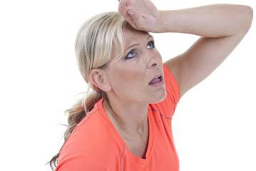 Attractive blond model in orange shirt looking tired after work