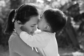 Son kissing his mom at forehead