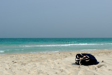 purse on a white beach in abu dhabi
