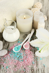 Beautiful spa setting with lily on wooden table close-up