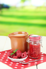 Fresh raspberry, raspberry jam and cream in jug