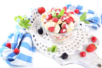 Fruit salad in glass bowl, isolated on white