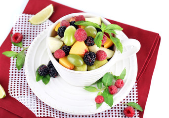 Fruit salad in cup on napkin isolated on white
