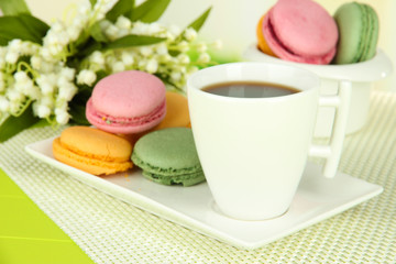 Coffee and macaroons on table close-up