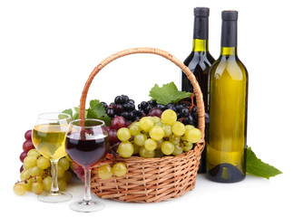 bottles and glasses of wine and grapes in basket, isolated