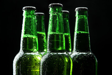 Bottles of beer on black background