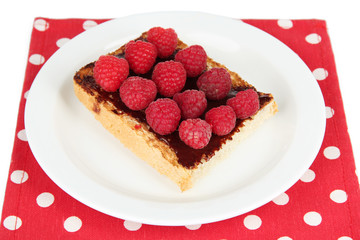 Delicious toast with raspberries on plate close-up