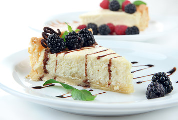 Slices of cheesecakes on plate, close-up