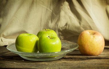 Still life green and red apple on dish