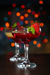 Two cocktails with fresh berries,on bright background