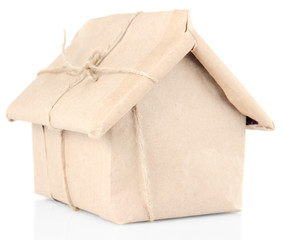 House wrapped in brown kraft paper, isolated on white