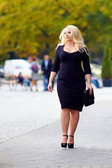 attractive overweight woman walking the city street