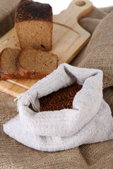 Fototapeta na wymiar Cloth bag with buckwheat and bread closeup