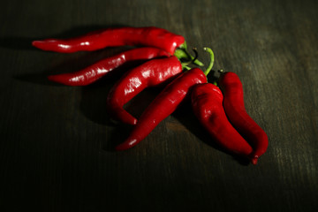Red hot chili peppers on wooden background