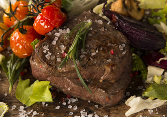 Grilled steaks on wood