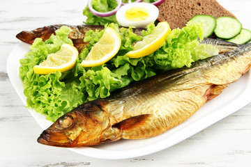Smoked fish on plate close up
