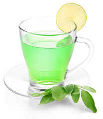 Transparent cup of green tea with sage and lime isolated