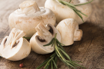 Fresh champignon mushrooms on wood