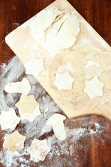 Dough for Christmas cookies on wooden board on table
