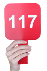 Hand holding  auction paddle isolated on white