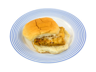 A piece of cooked haddock on a white bun