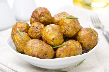 bowl of baked new potatoes with spices and rosemary