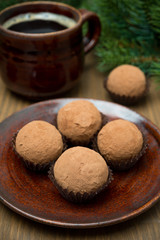 chocolate truffles and a cup of coffee, selective focus