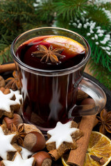 cookies in the shape of stars, spices and a cup of mulled wine